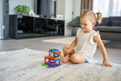 Boy playing with toy blocks at home