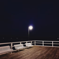 Empty seats on table at night