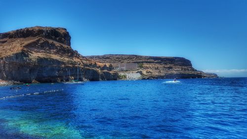 Scenic view of sea against clear blue sky