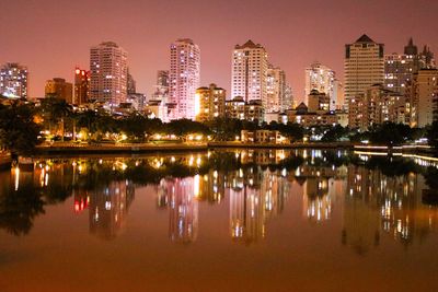 Reflection of illuminated buildings in city at night