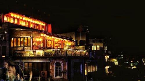 Illuminated buildings in city at night