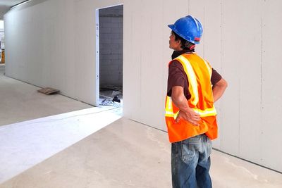 Man working against wall