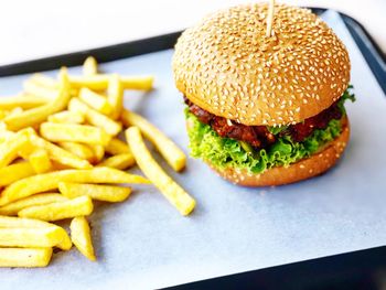 Close-up of burger and french fries on table