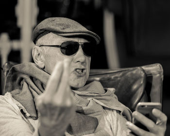 Man using smart phone while sitting on chair