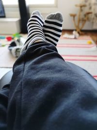 Low section of man relaxing on floor