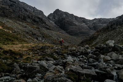 Low angle view of man hiking on mountain