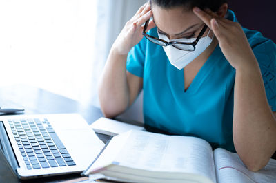 Midsection of woman reading book