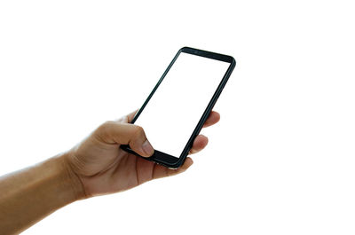 Low angle view of hand holding smart phone against white background