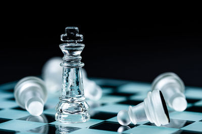 Close-up of chess pieces against black background