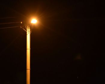 Low angle view of lamp post at night