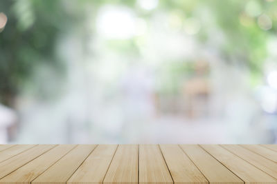 Close-up of wooden bench on footpath