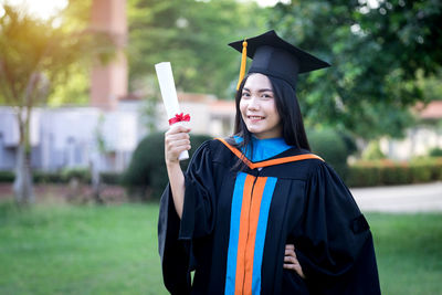 Smiling young woman standing outdoors