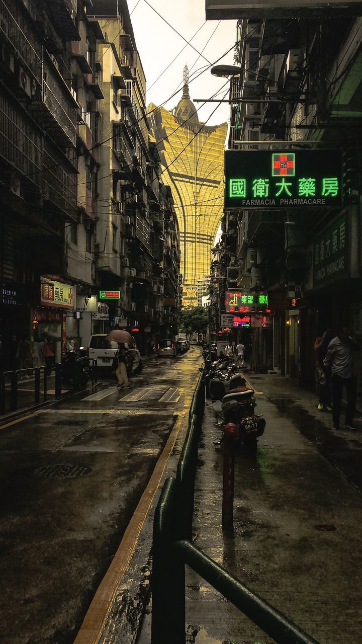 ROAD BY BUILDINGS IN CITY DURING SUNSET