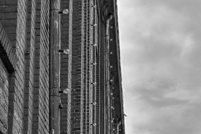 Low angle view of building against cloudy sky