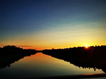 Scenic view of lake against romantic sky at sunset