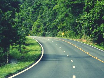 Empty road along countryside landscape