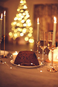 Close-up of illuminated candles on table