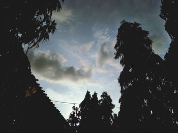 Low angle view of silhouette trees against sky at sunset