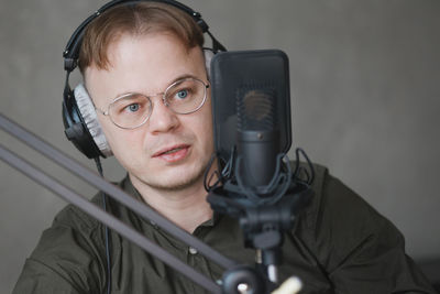 Portrait of young man with microphone