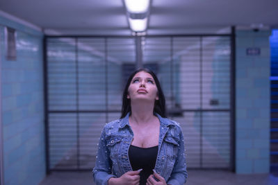 Portrait of a young woman looking up