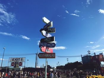 View of road sign against blue sky