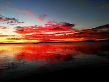 Scenic view of lake against romantic sky at sunset