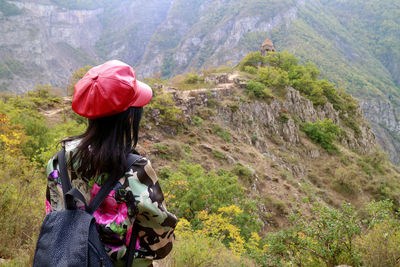 Rear view of woman with umbrella on mountain