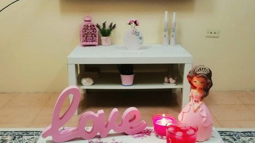 Low angle view of pink cake on table