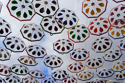 Full frame shot of umbrellas against cloudy sky