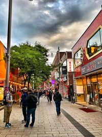 Group of people walking on street in city