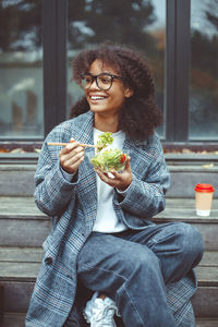 Smiling woman having salad