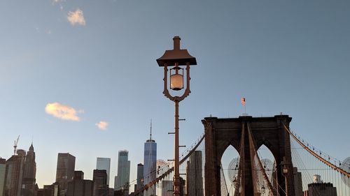 Low angle view of street light and buildings against sky