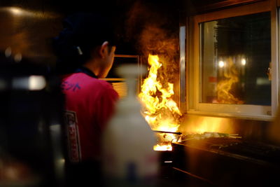 Rear view of man standing at night