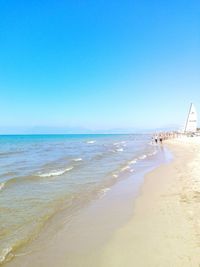 Scenic view of beach against blue sky