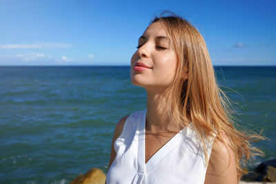 Close-up woman relaxing breathing fresh air on sea