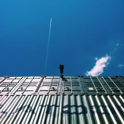 Low angle view of modern building against blue sky