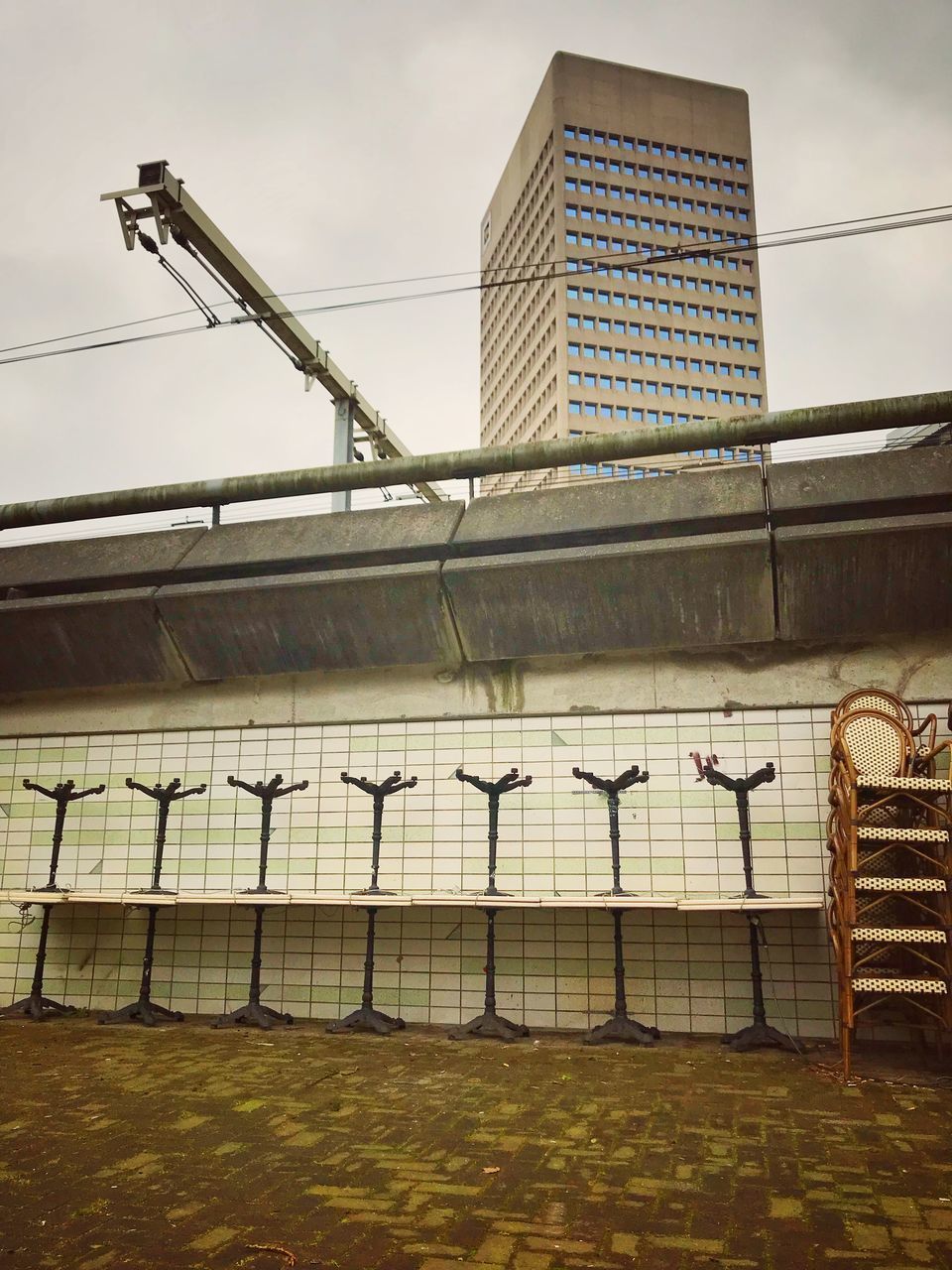 LOW ANGLE VIEW OF BUILDING BY FENCE AGAINST SKY