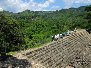 Rear view of people on mountain against sky