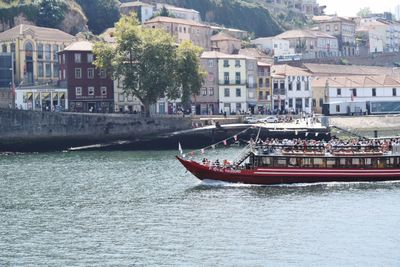 Boat sailing on river in city