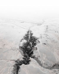 Scenic view of stream amidst snow covered land