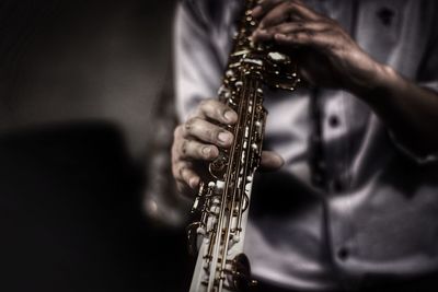 Close-up of man playing guitar