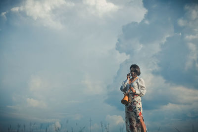 Low angle view of man looking in sky