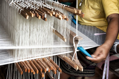 Cropped image of hand weaving on handloom