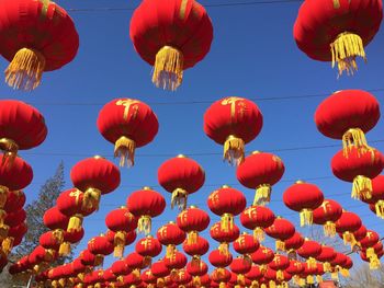 Low angle view of lanterns hanging against sky