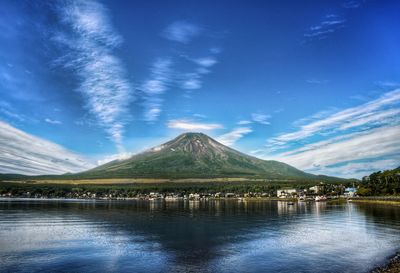 Scenic view of lake with mt fuji against blue sky. 