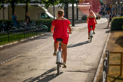 Rear view of woman riding bicycle
