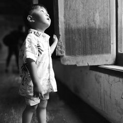Girl looking away while standing at home
