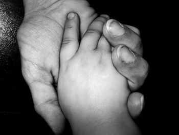 Close-up of baby holding hands