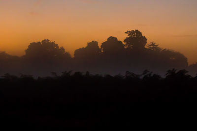 Silhouette of trees against sky during sunset