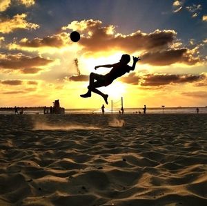 Silhouette of person volley ball on beach